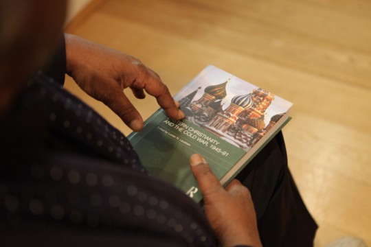 Dr Mike Phillips holding a copy of the 'Eastern Christianity and the Cold War, 1945-91'