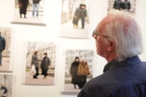 A member of the audience in front of the panel documenting 'The Shops Project' in Iasi