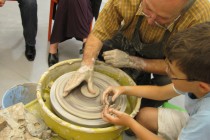 ... a young visitor builds up his own little clay pot