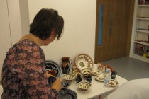A member of the audience admiring a small display of Cornel Sitar's work