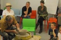 Cornel Sitar shows the audience how to build up a clay pot