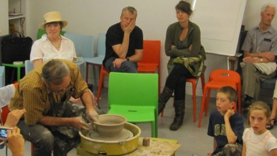 Cornel Sitar shows the audience how to build up a clay pot