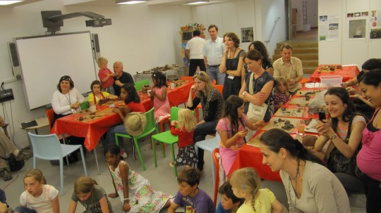 The audience watching the master at work, eager to experiment on the potter's wheel