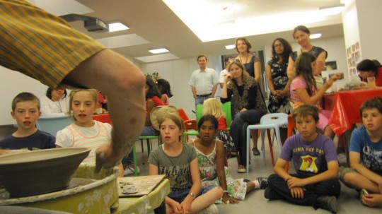 A captivated audience watching a master craftsman at work