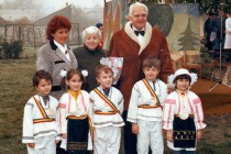 Ion and Elisabeth Ratiu with a teacher and a group of children at a school celebration, mid-1990s