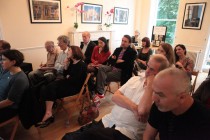 The audience of the event. In the lower-right corner, journalist George Stanica